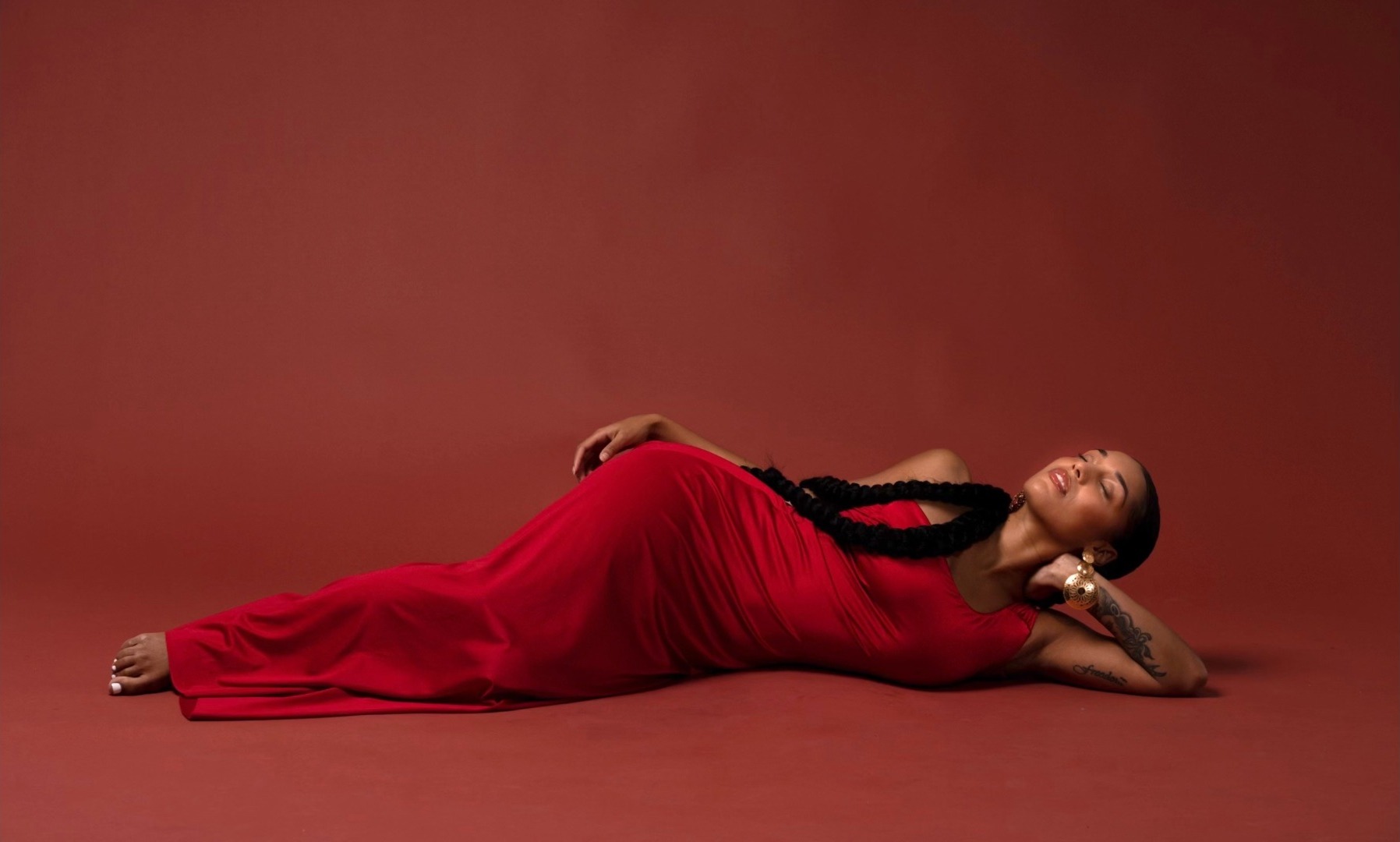 Alexa Rainville lying down in red
